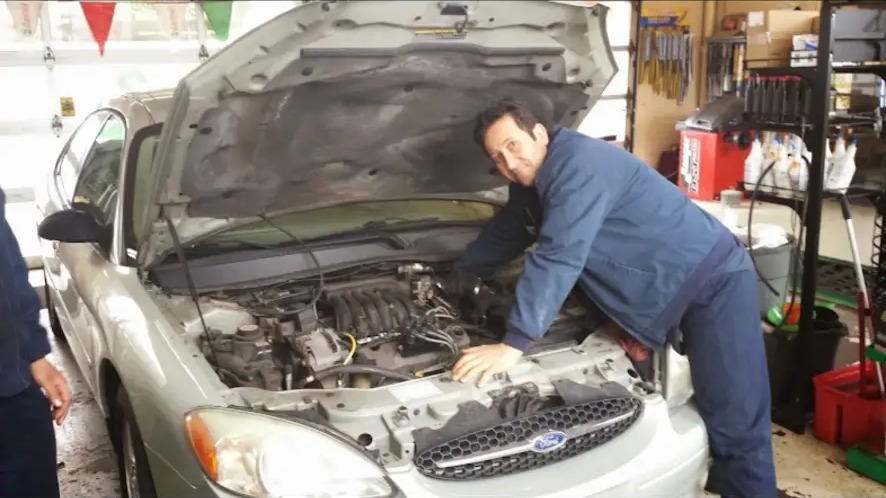 Mechanic working under the hood of a car