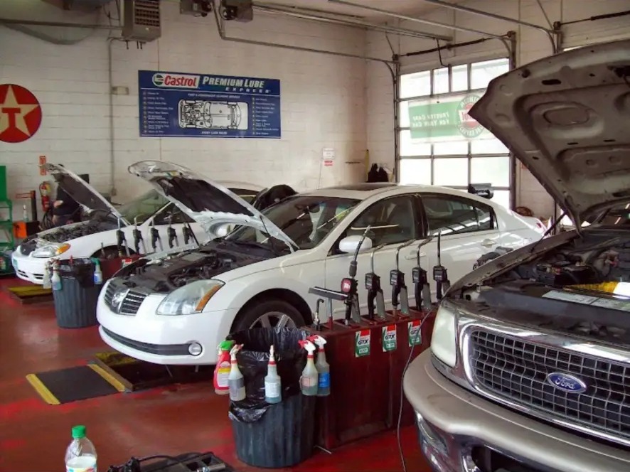 Three cars in the shop getting oil changes at once