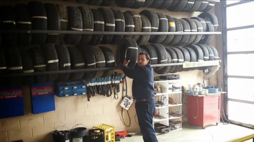 Wall of tires stocked inside the shop